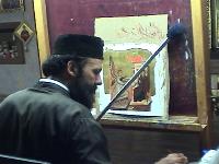 Artist demonstrating the depositing of the gold leaf on icon